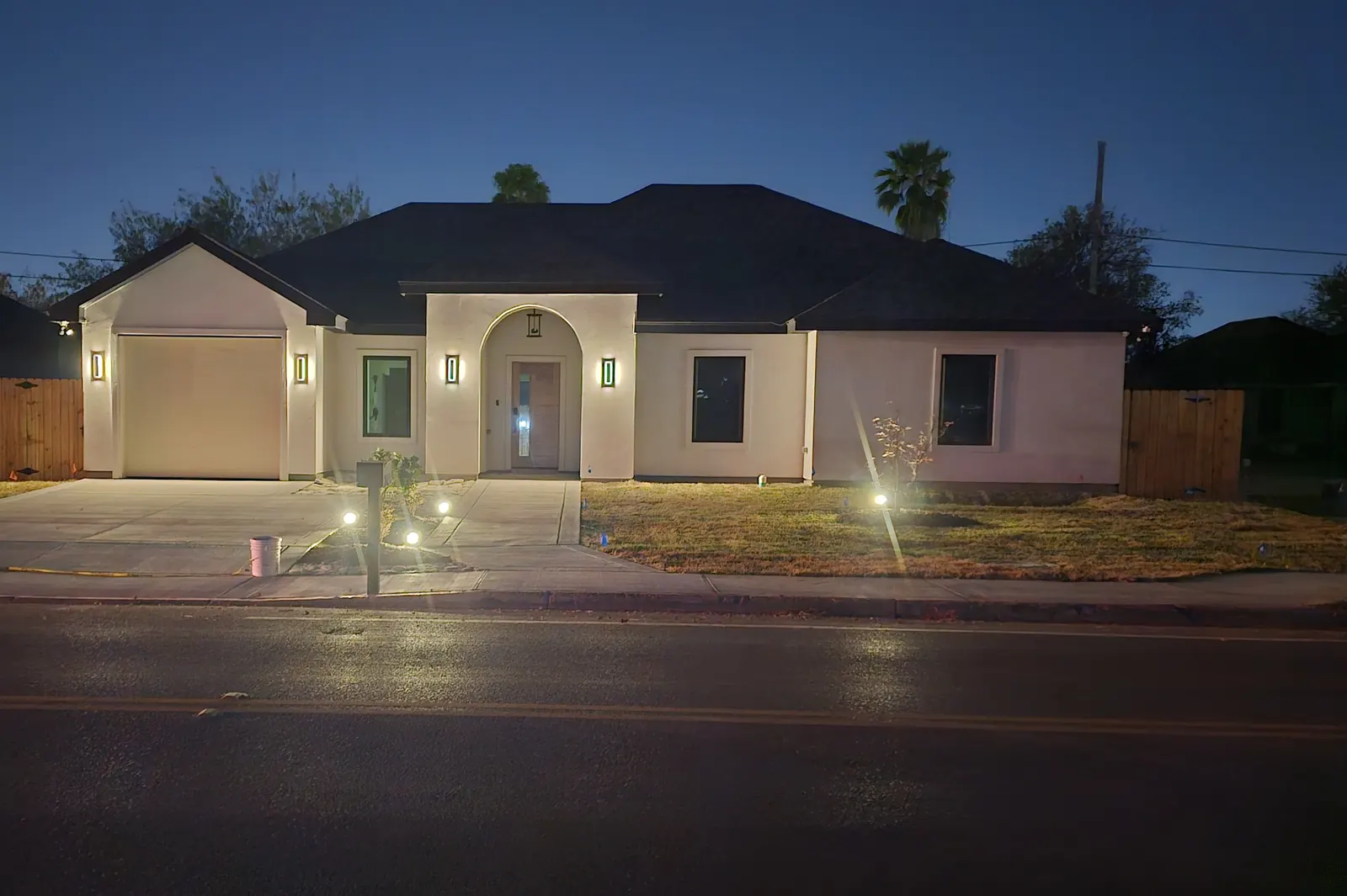 Photograph of a finished EJS Trade home at dusk with the lights on.